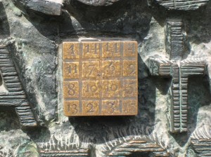 Close-up of bronze plaque (it is a "magic  square -- each row and column sum to 33, Jesus' age at crucifixion)