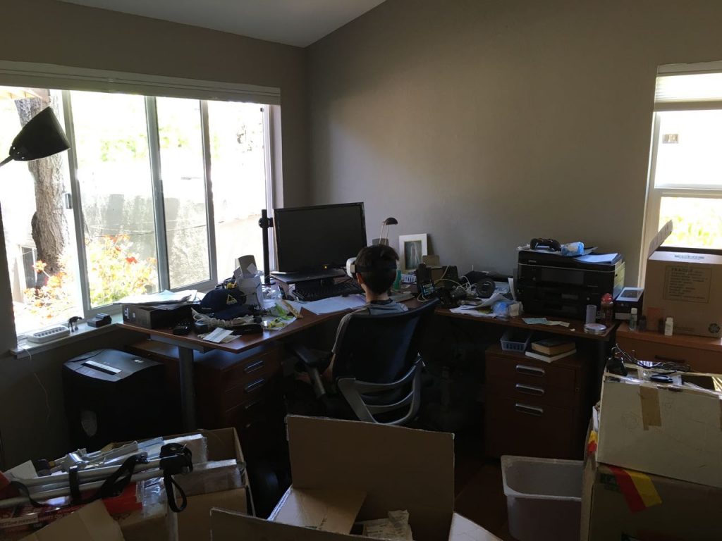 Jonas viewing a game using a virtual reality headset in Jusok's office room.