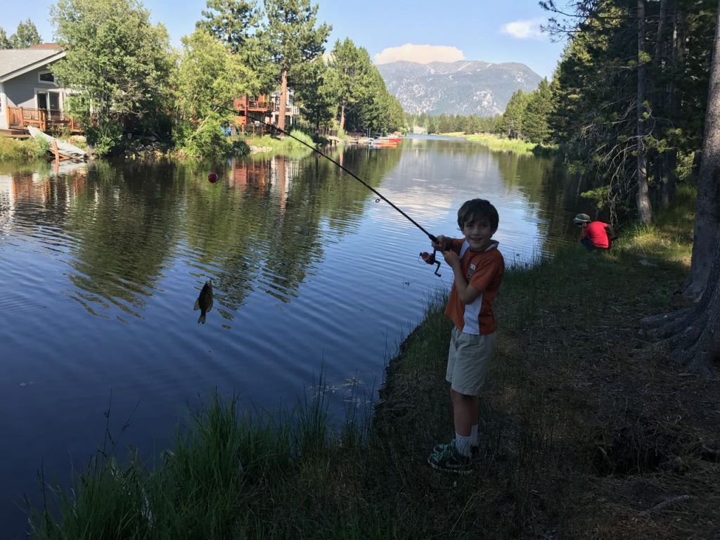 Holland catches a fish in the lagoon.