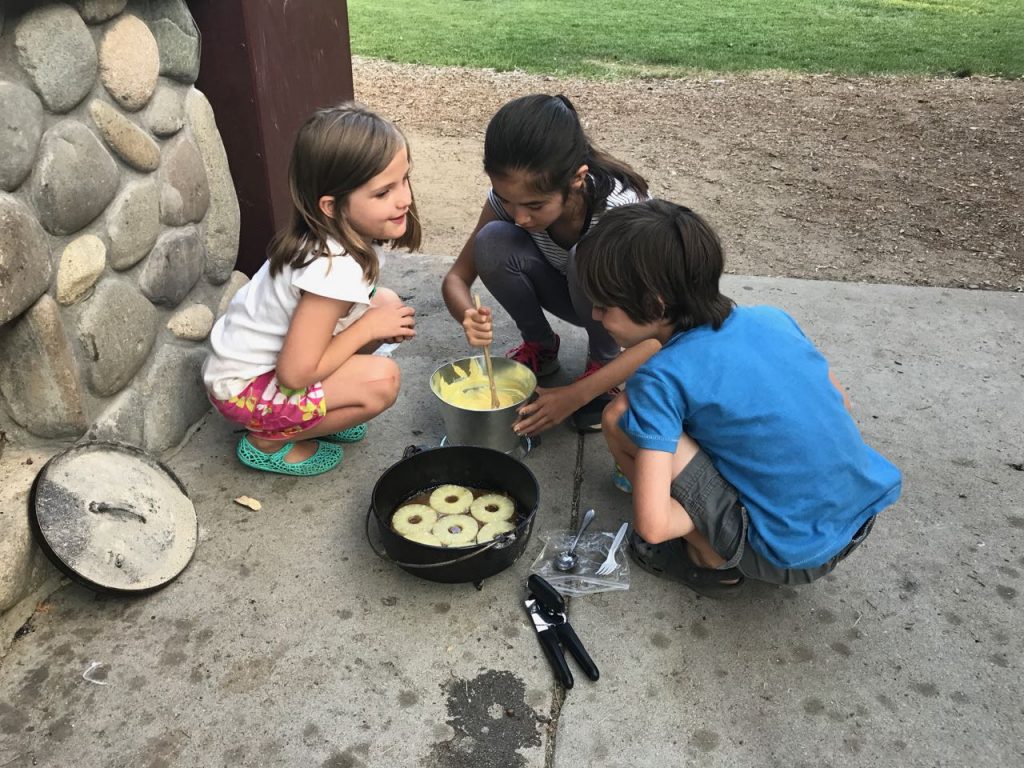 Felicity, Rachelle and Beckett make a pineapple upside-down cake at Bijou Park.